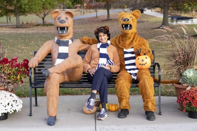 Three Nittany Lions seated on a bench